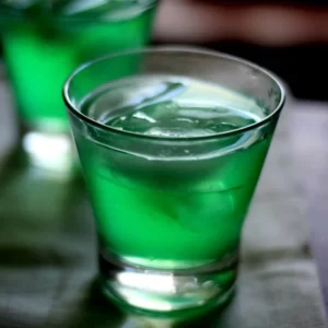 Gideon's Green Dinosaur cocktail served in a Collins glass