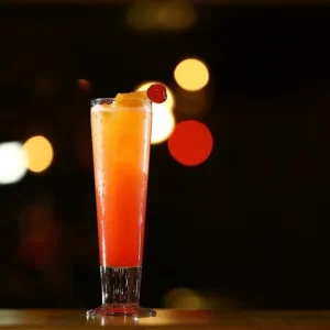 Amaretto Sunset cocktail served in a Collins Glass