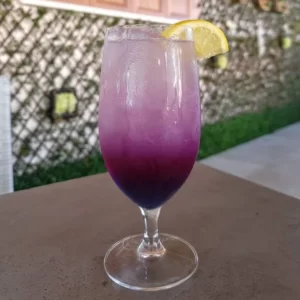 Butterfly Effect cocktail served in a Hurricane glass